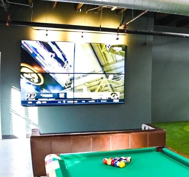 Lounge with video wall and pool table at Ravenswood Golf Club